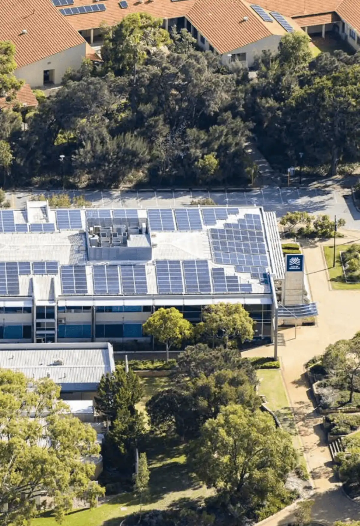 Aerial image of commercial building with solar panels. 